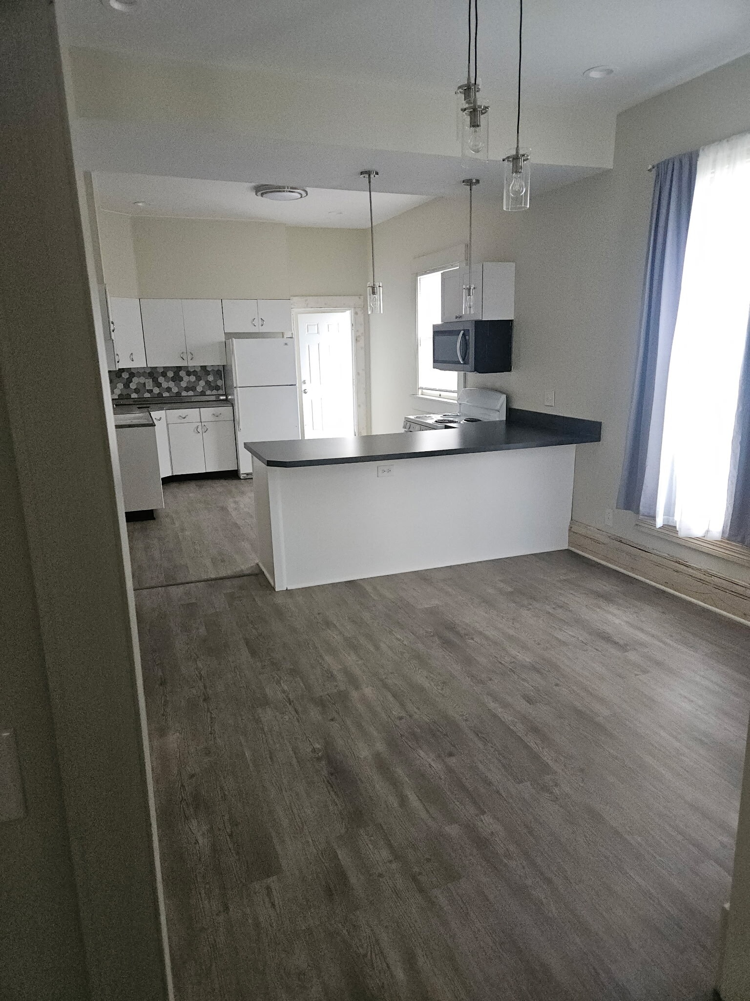 Open kitchen/dining room with wall being TV ready to watch your morning news while you cook - 728 S 15th St