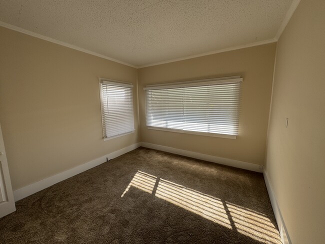 Newly renovated second bedroom. Large south facing window. - 1749 E 3rd St