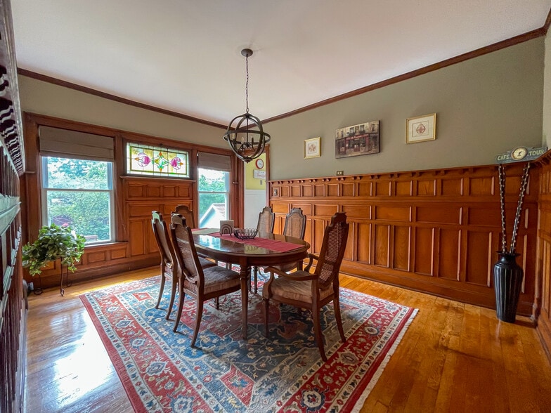 [Dining room] Features all-original wood paneling, and stained-glass window. - 103 Lancaster Ave