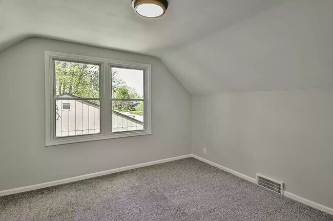 Upper bedroom 1 with new carpet and lighting - 743 Marie Ave