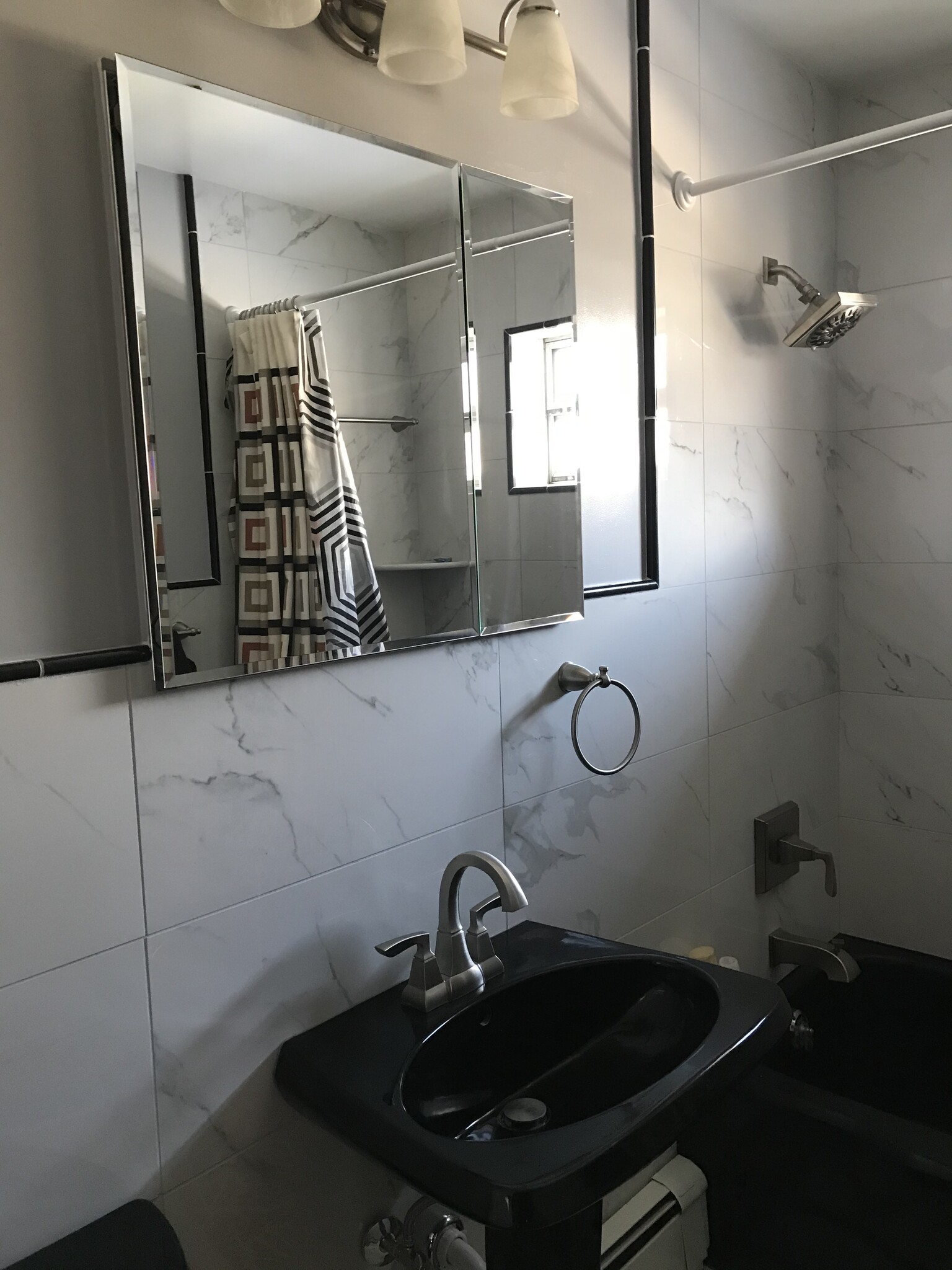 Elegant Carrara tile in bath 1 - 6012 Donlar St