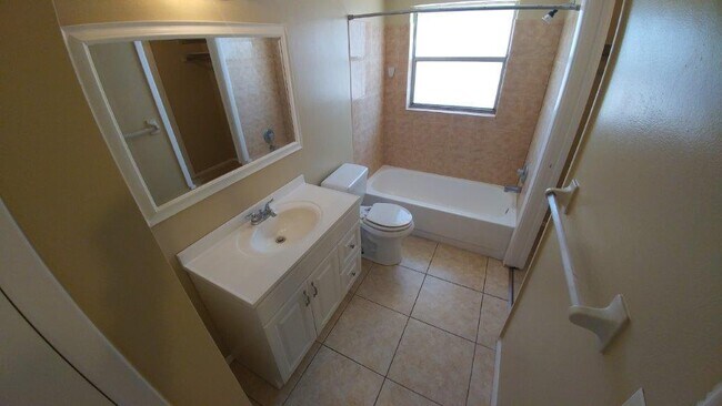 Building Photo - Large 2/2/1 1060 sq ft home with INDOOR LAUNDRY, a full garage, updated kitchen and a fenced in y...