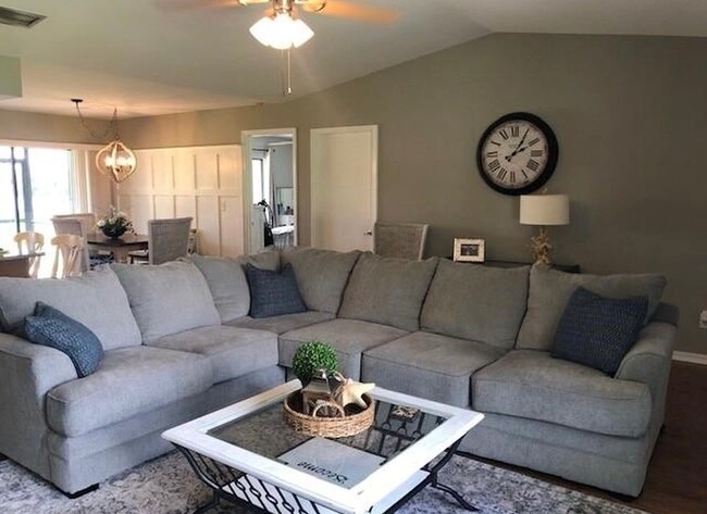 Open living/dining area with wood laminate flooring thru out. - 2321 SE 5th Ct