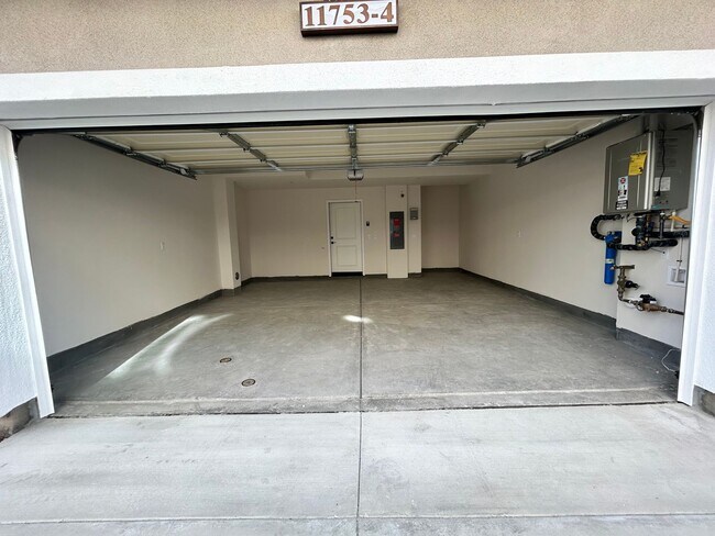 Building Photo - Gorgeous, 3 level townhome, featuring 2 car garage central Air, and in Unit laundry.