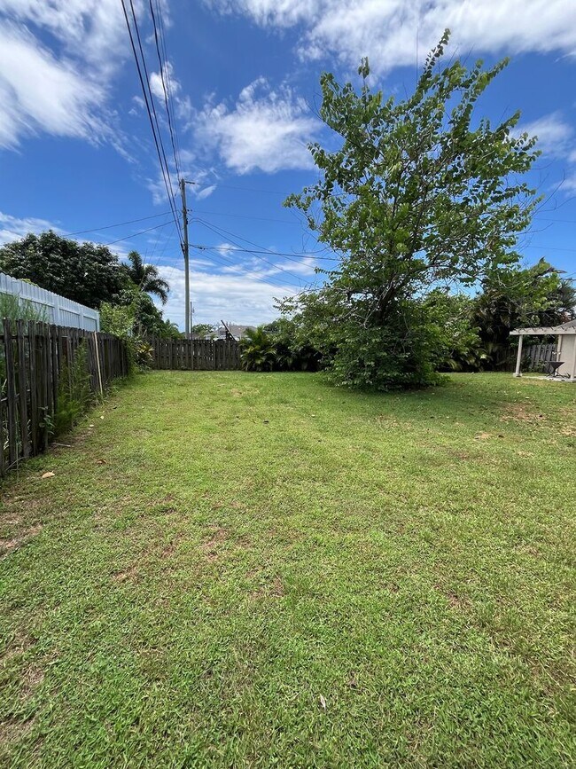 Building Photo - 2/2/1 home with a spacious fenced backyard...