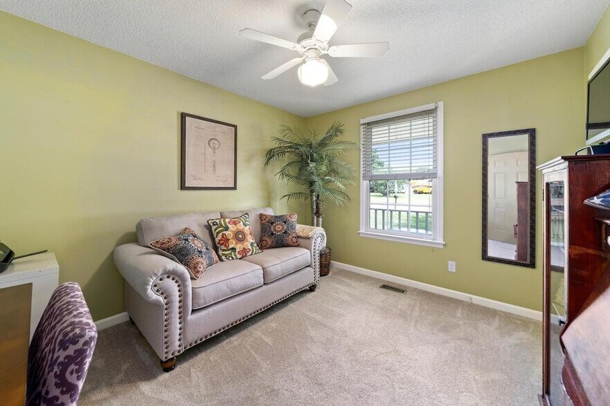 Second bedroom with ceiling fan - 1102 Tobacco Rd