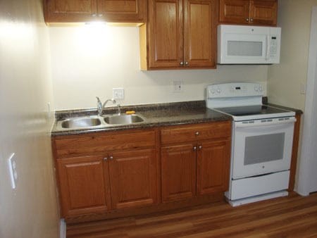 Kitchen sink; stove and microwave on right.. - 522 E Market St