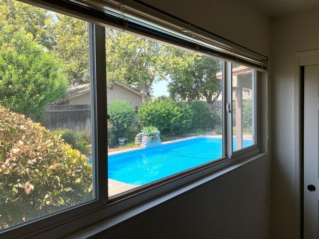 Building Photo - Enjoy the Backyard Pool at This 4-Bedroom ...