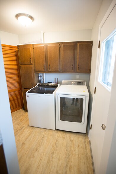 Included washer and dryer and extra storage. Not shown is a utility sink to the left. - 18909 Lorenz Ave