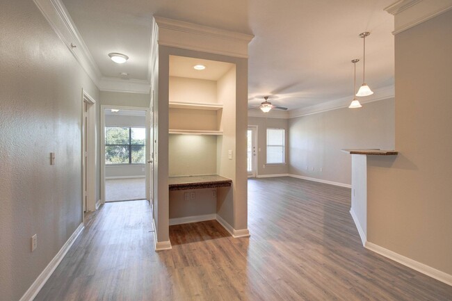 Open Floor Plan Living Area with Built-In Desk - Carrington at Champion Forest Apartments