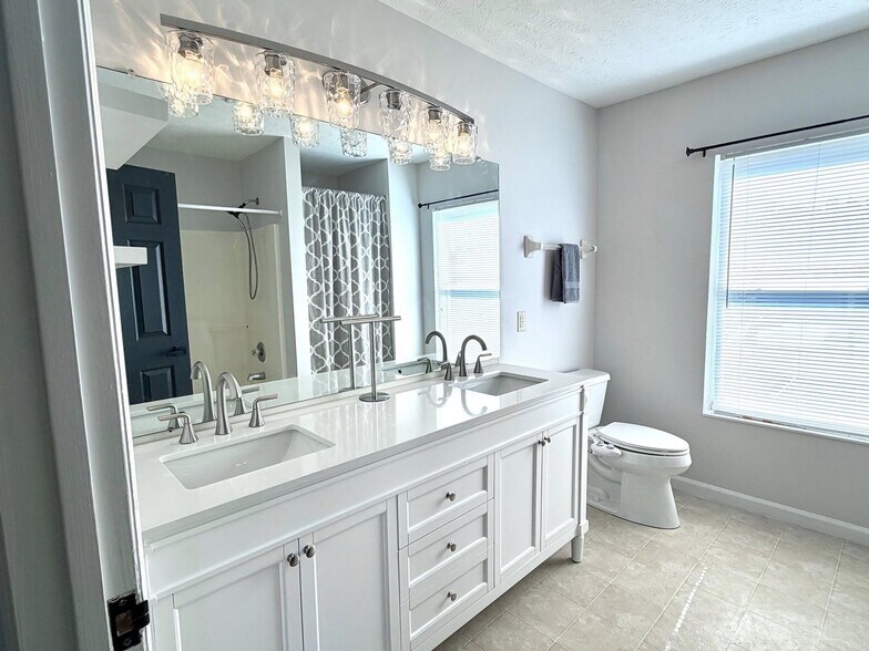 Primary bath with high end double vanity with marble top, new lighting - 1200 Bugle Bluff Ct