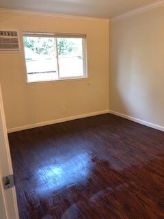 Front bedroom with newer laminate flooring, newer A/C, heating and fan with remote control. - 375 N M St
