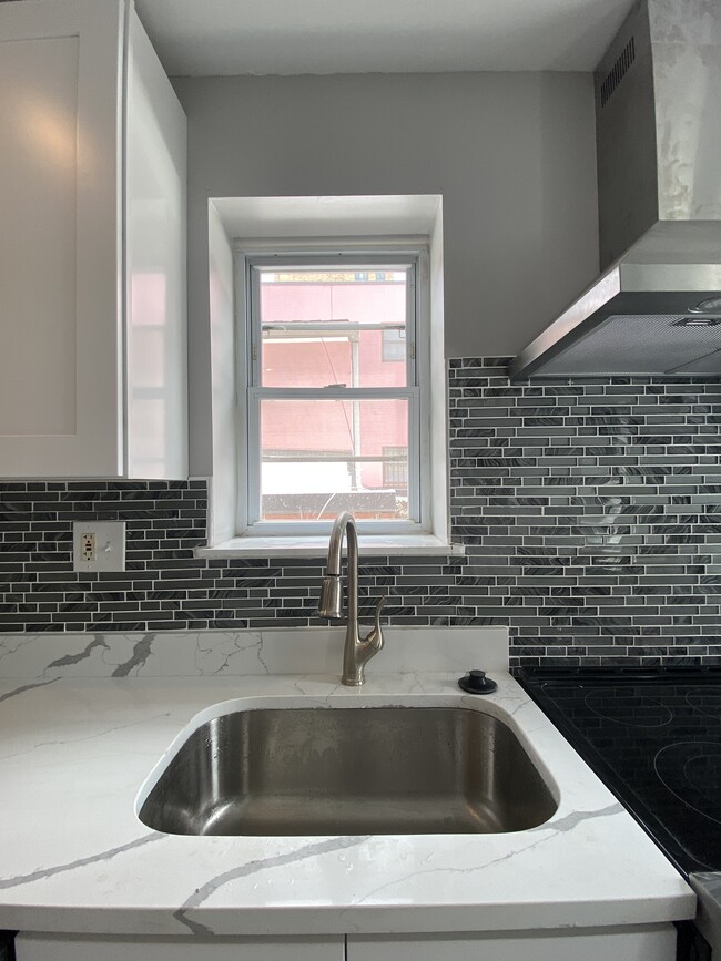 Large sunny modern white kitchen, quartz countertop, porcelain tile floor, stainless steel appliance - 1618 Fitzwater St