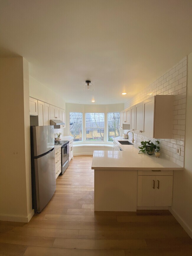 Beautiful bright new kitchen with bay windows and a window bench with storage inside! - 2608 E Madison St