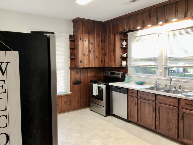 Kitchen with stainless steel appliances, new electrical, new plumbing, new flooring, new countertops, new fixtures, new lighting, and large Pantry. - 2205 Mayflower Dr