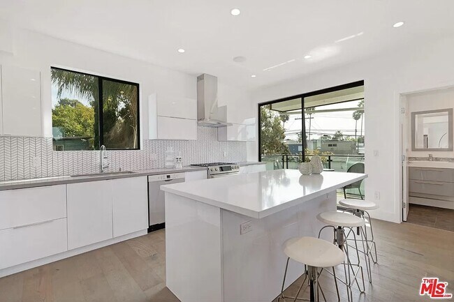Large, South-facing sliding door provides access to kitchen balcony - 6077 Hargis St