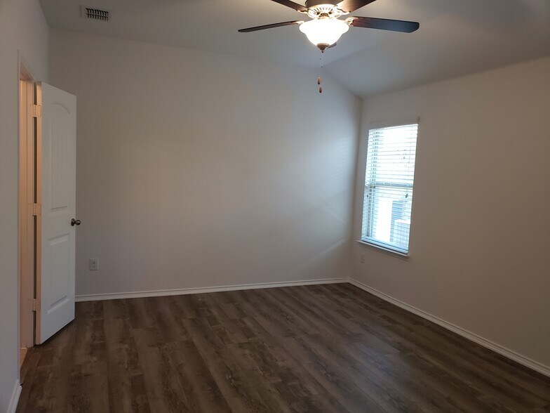 Spacious master bedroom with ceiling fan. - 14557 Serrano Ridge Rd
