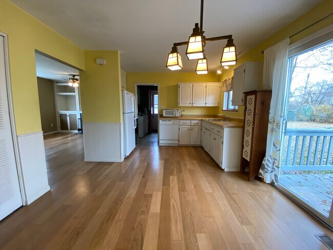 Kitchen and dining with slider door access to large deck and backyard - 618 Clayton Ave NW