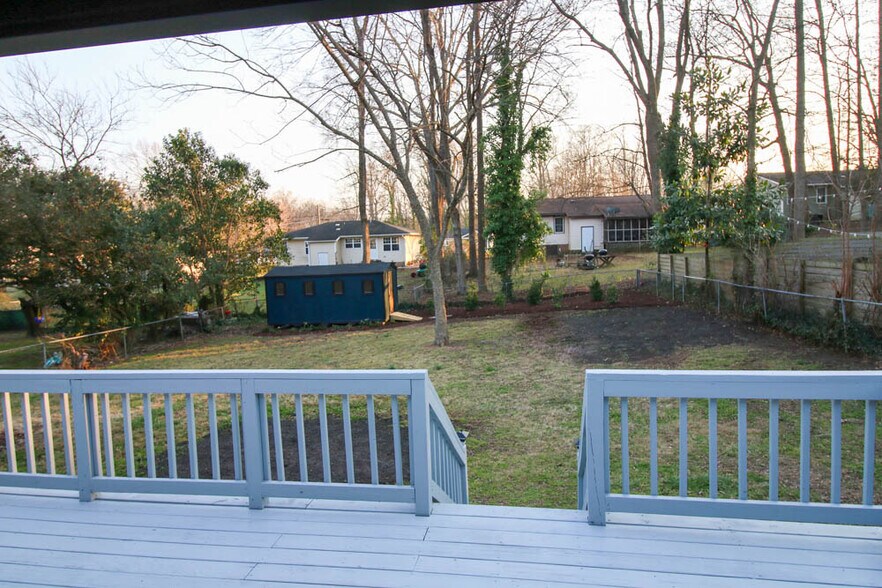 Large fully fenced in yard is ready for your pup to play in. - 2406 Boswell Rd