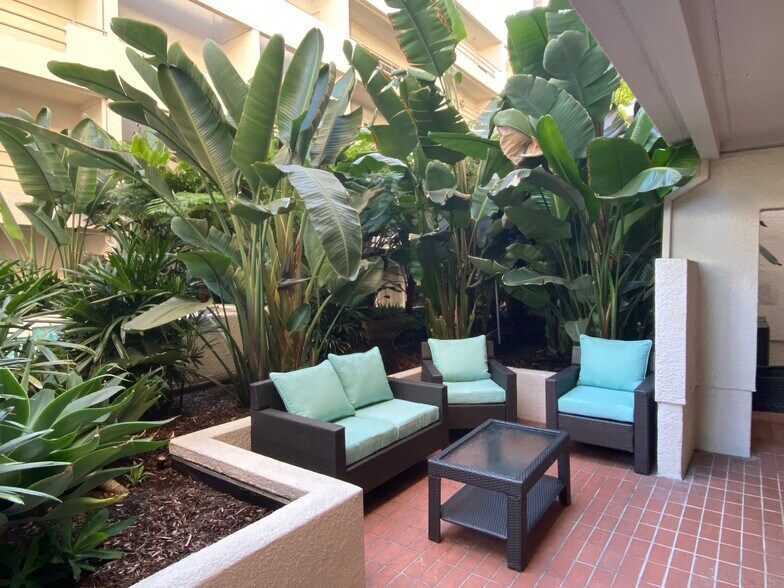 Your own private unit patio with patio furniture, tropical plants, and a water feature nearby - 1131 Alta Loma Rd