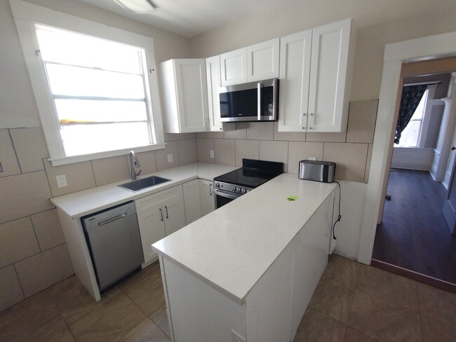 Remodeled kitchen with dishwasher, pull out sink and eating bar - 2345 Fulton St