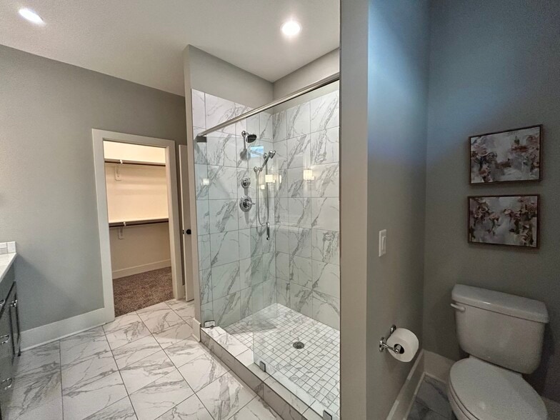 Primary bedroom with ensuite bathroom and separate his and her closets - 405 E 32nd Ave