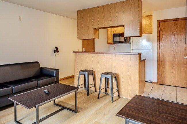 Living room and updated kitchen - Varsity Campus Apartments