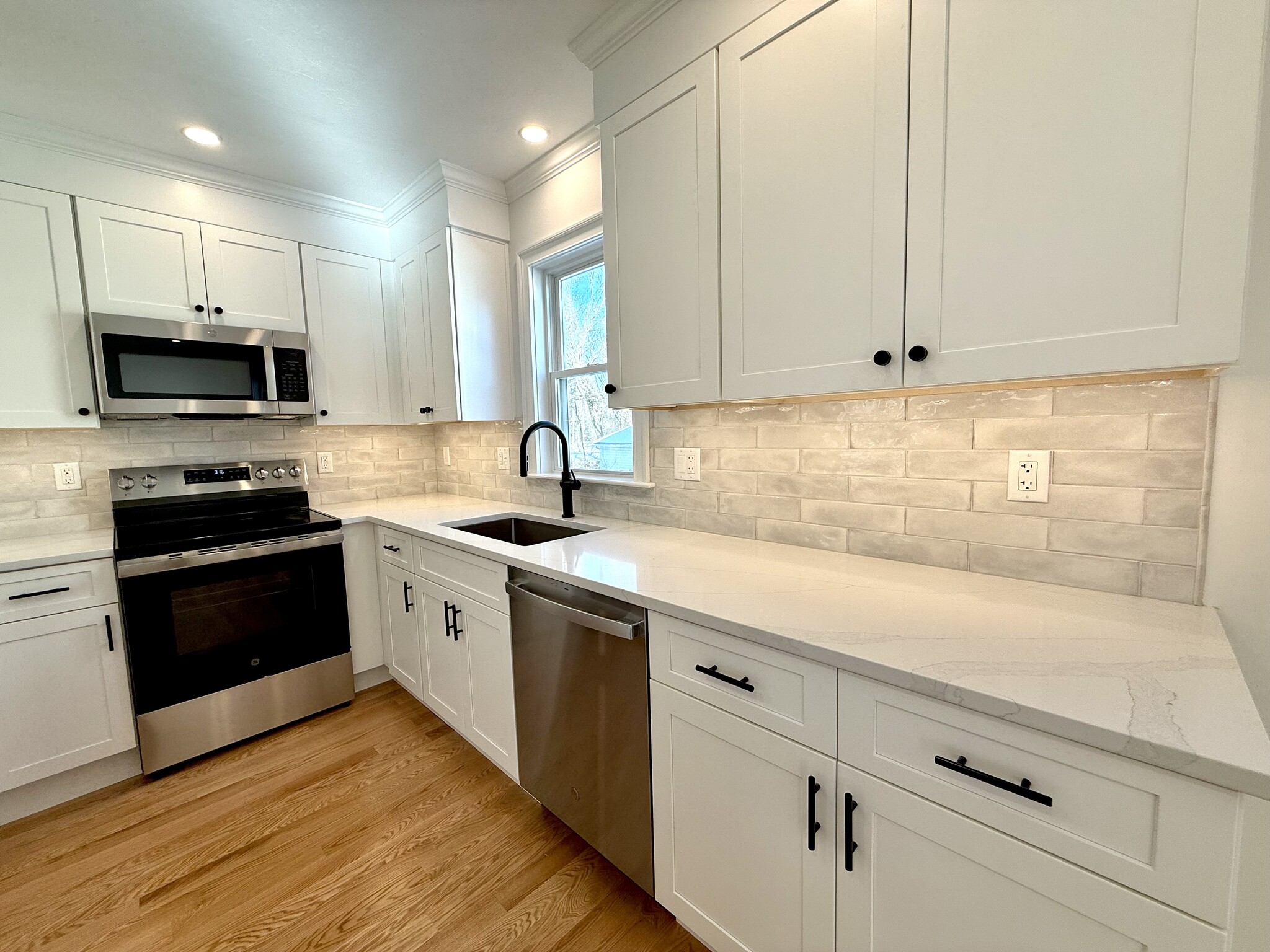 Kitchen: Brand New Stainless Steel Appliances, Quartz Countertops with Open Layout into Living Area - 34 Saint Joseph Ave