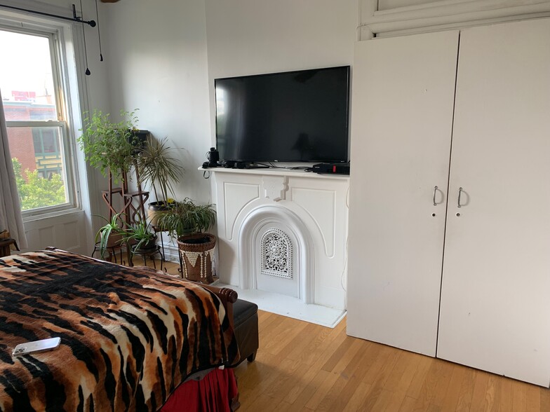 Primary bedroom with original fireplace mantel - 292 Jefferson Ave