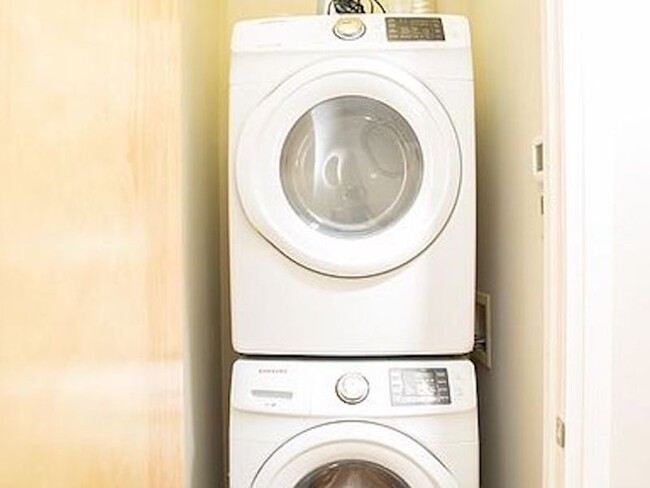 Laundry room with washer and dryer. - 300 Van Buren St