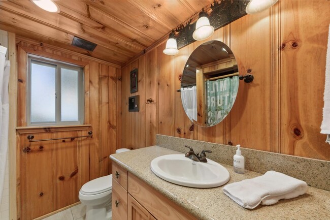 Bathroom with walk in shower and stacked washer dryer - 1139 Craig Ave