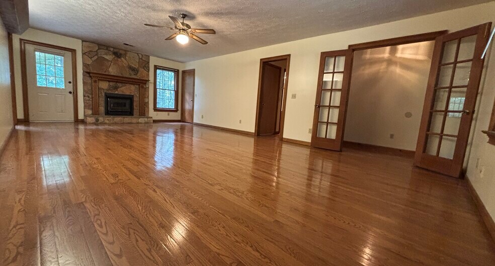 Livingroom with hardwood floors and wood-burning stove - 705 Alcovy Forest Dr