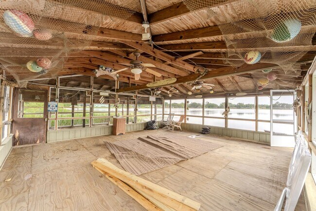 Building Photo - Lake Jessamine Luxury: Solar-Powered Waterfront Retreat on 1.14 Acres with Dock & Boathouse