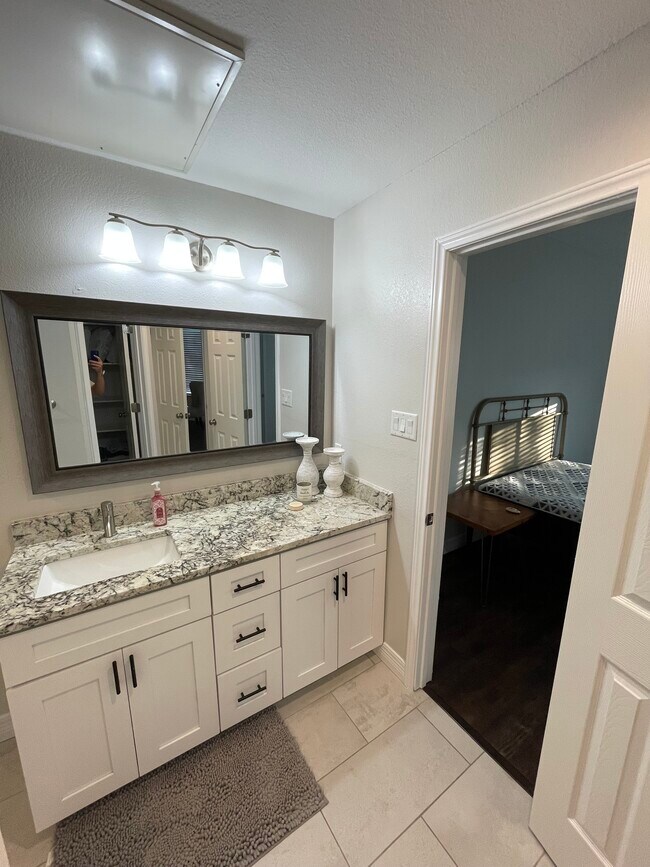 View of single bathroom of view of bedroom door acess - 5550 Spring Valley Rd