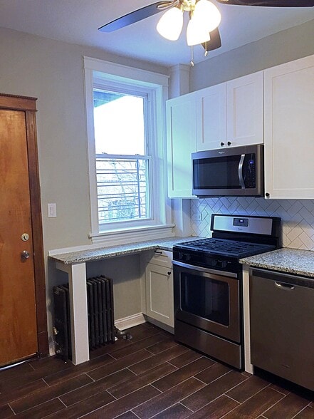 Recently renovated kitchen with granite countertops and stainless steel appliances. - 5339 S Maryland Ave