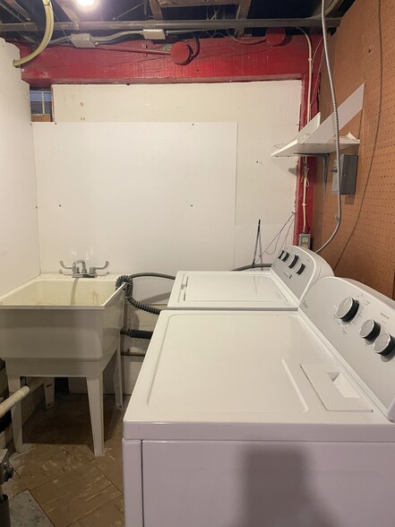 Laundry room with laundry sink in lower level. - 1231 Raymond Ave