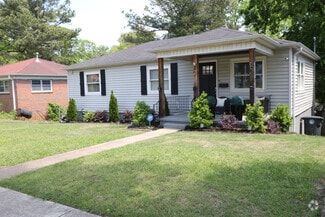 Discover this elegant home showcasing a striking black door, classic black shutters, and a beautiful - 1617 27th St N