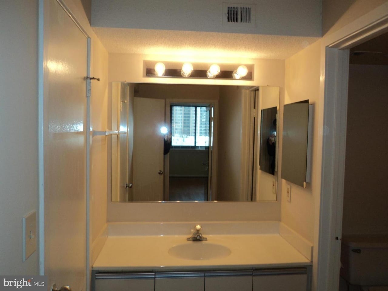 Bathroom sink with large mirror and medicine cabinet - 5505 Seminary Rd