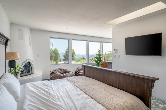 Master bedroom with Kiva fireplace and view - 7401 Studio Rd