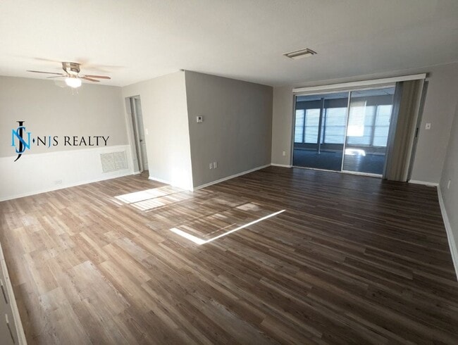 Building Photo - 2/2/1 with  RENOVATED baths & kitchen, fenced yard, NEW lvp flooring and a OVERSIZED lanai!