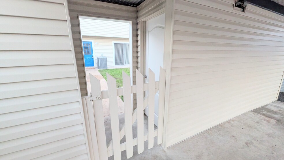 Extra storage can be found by the carport with this large, lockable storage room. - 813 Clubside Dr