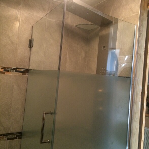 Remodeled bathroom. Glass shower enclosure, custom tile surround. Multi-jet shower tower. - 3000 Clarcona Road