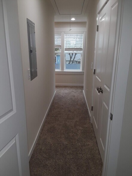 Hallway to the bedrooms. Washer and dryer on the right. - 8814 N Edison St