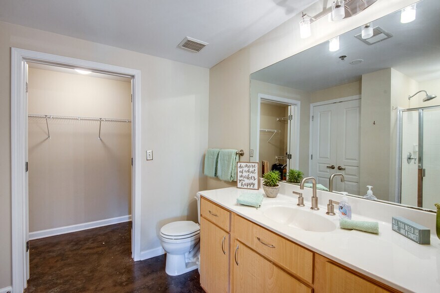 Master bathroom with linen closet, walk in shower, and walk in closet - 1803 Broadway