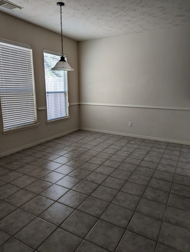 Large dining room looking in from the kitchen, includes a breakfast bar. - 5910 Hollister Cole