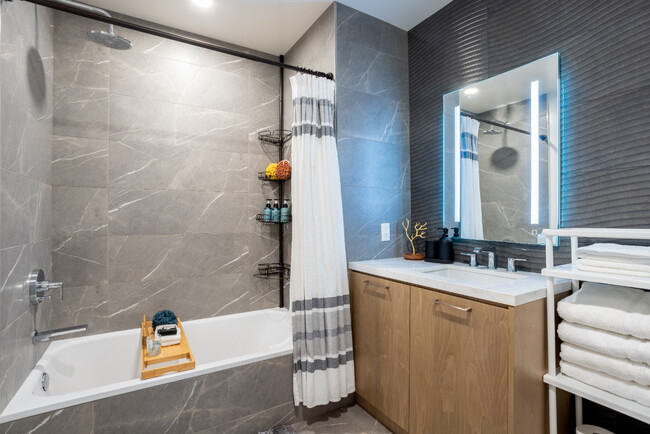 Experience tranquility in this expansive bathroom, complete with a soothing extra deep bathtub - 400 S Broadway