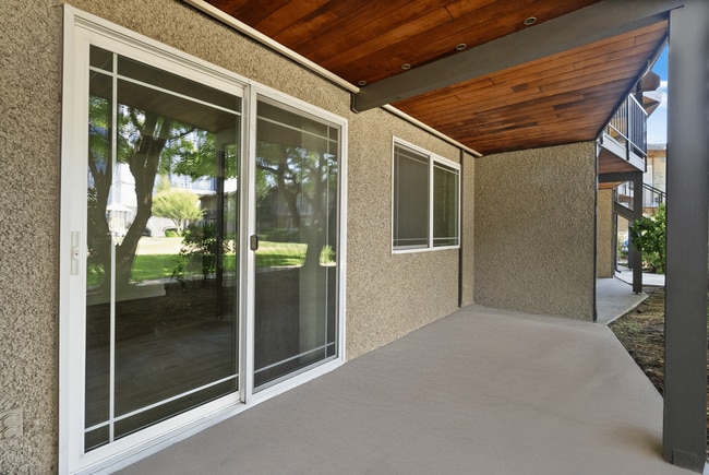 Private covered patio with easy outdoor access. - Rainier Gardens Aparments