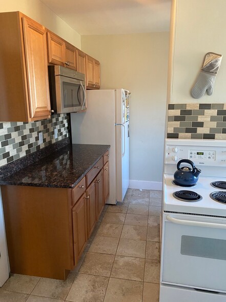 Kitchen with granite counter and built-in microwave - 114 Brown St