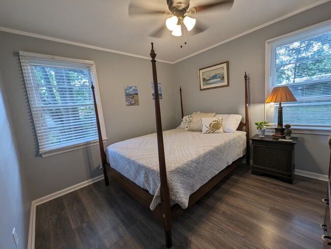 Bedroom 1 is bright and inviting. Queen bed, original art and a closet. - 4107 Crane St