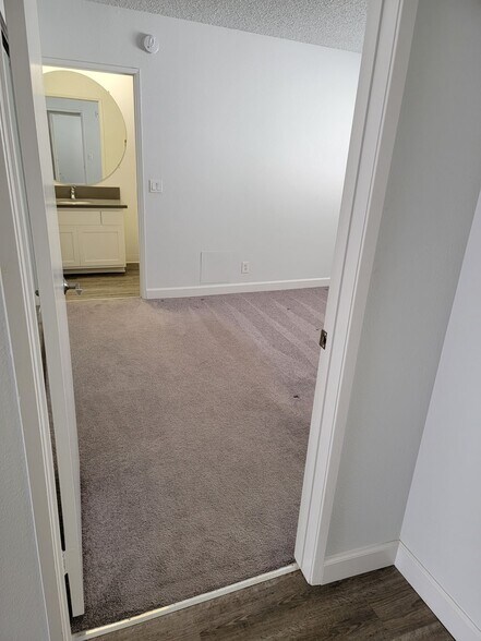 Doorway to primary bedroom with view to ensuite bathroom - 3751 S Canfield Ave